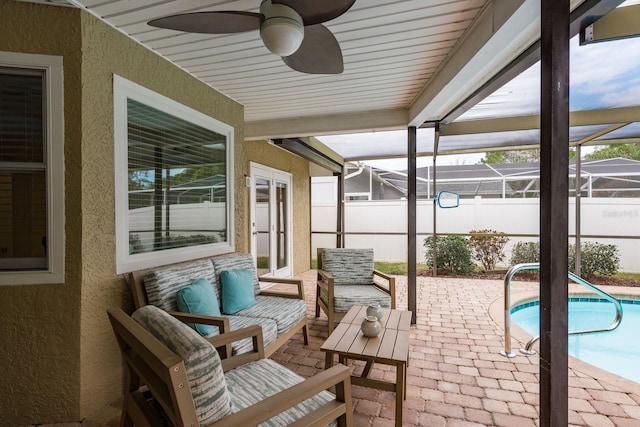 view of patio featuring a lanai, ceiling fan, a fenced in pool, and outdoor lounge area