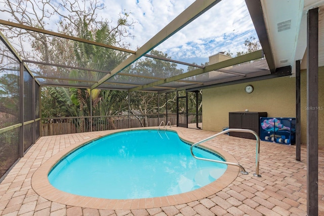 view of pool featuring a patio and glass enclosure