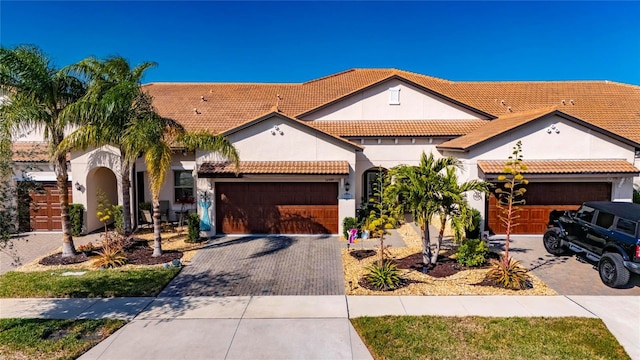 mediterranean / spanish home with a garage