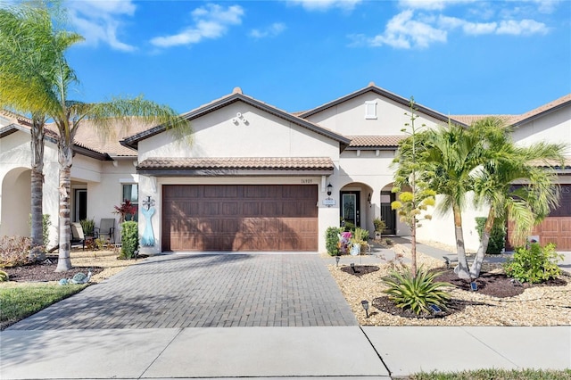 mediterranean / spanish-style house with a garage