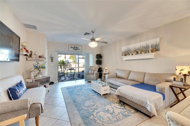 living room with light tile patterned flooring and ceiling fan