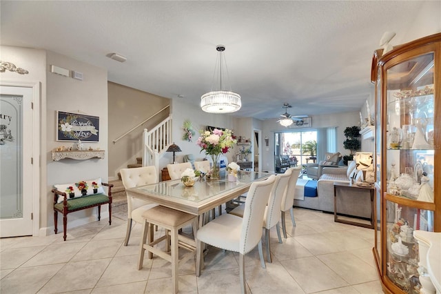 tiled dining area with ceiling fan