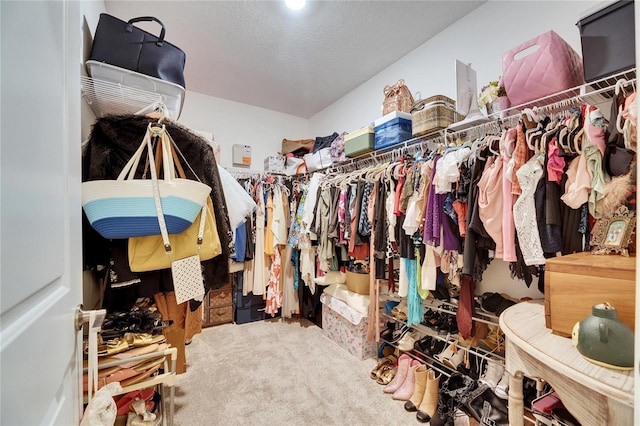 walk in closet with carpet