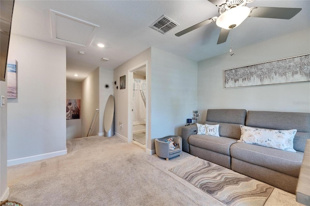 carpeted living room with ceiling fan