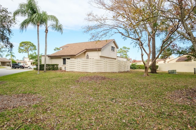 view of side of property featuring a yard