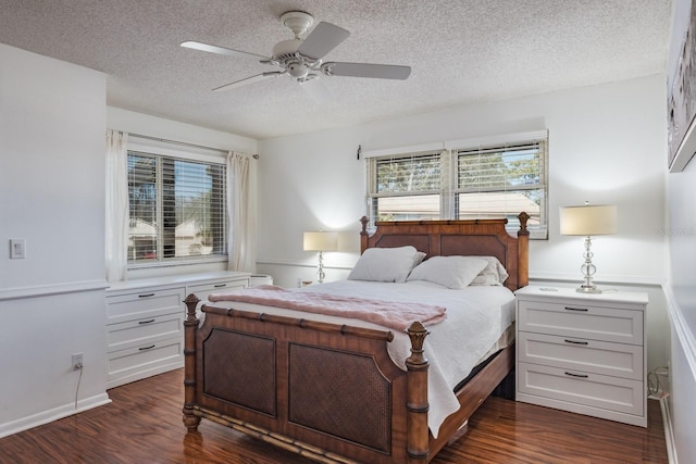 bedroom featuring dark wood-type flooring, ceiling fan, and a textured ceiling