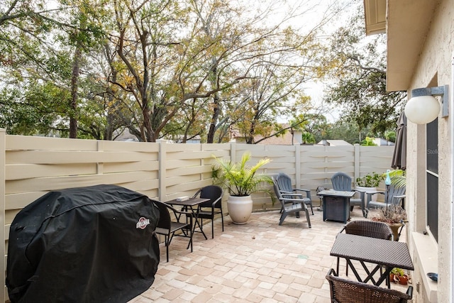 view of patio / terrace with a fire pit and area for grilling