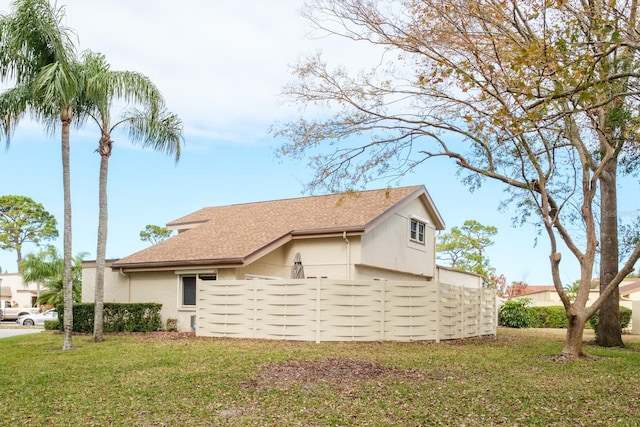 view of home's exterior with a lawn