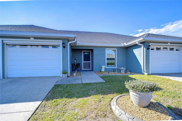 single story home with a front yard and a garage