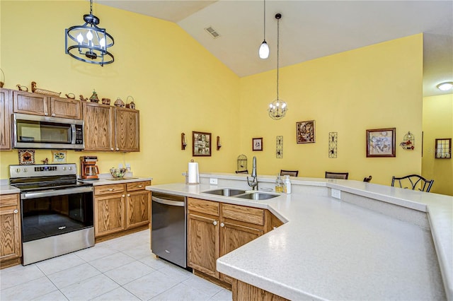 kitchen featuring stainless steel appliances, decorative light fixtures, and a chandelier