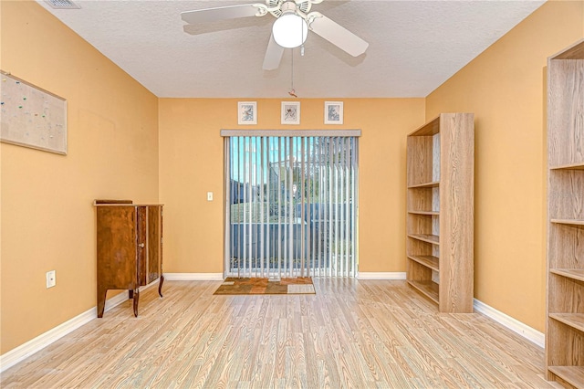 unfurnished living room with a textured ceiling, ceiling fan, and light hardwood / wood-style flooring