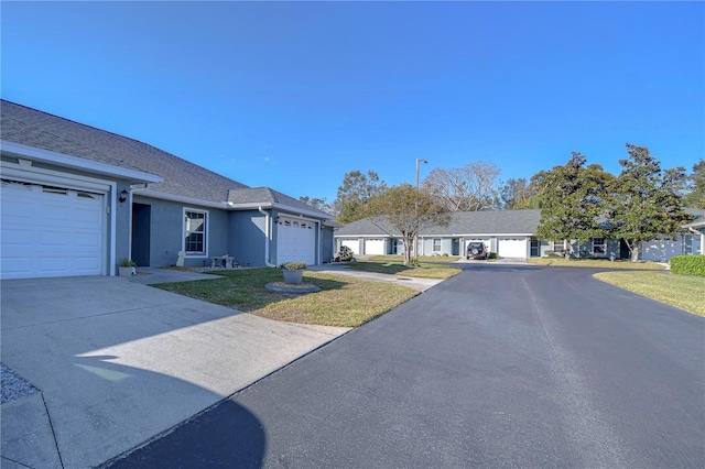 single story home with a front yard and a garage