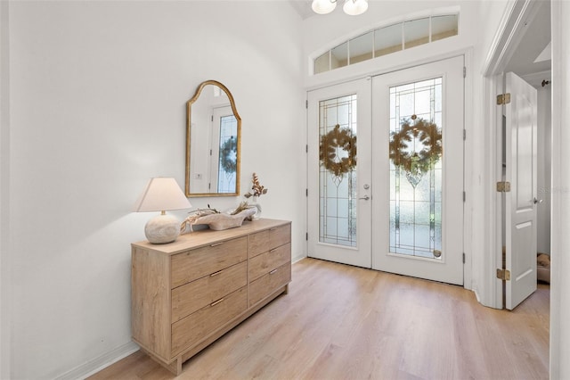 entryway featuring french doors and light hardwood / wood-style flooring