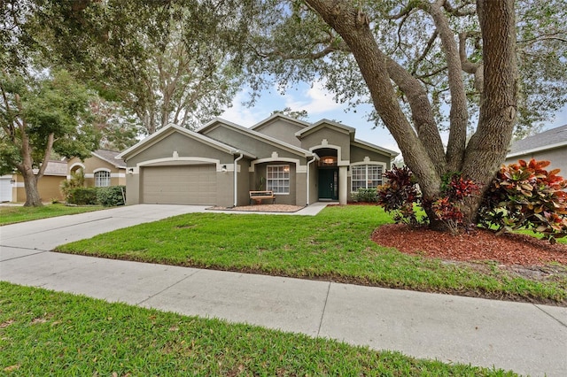 ranch-style home with a garage and a front lawn