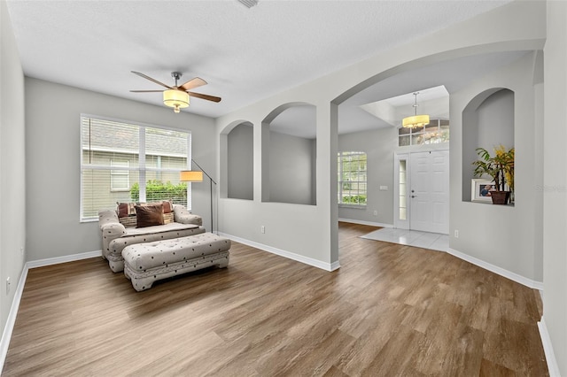 entryway featuring a textured ceiling, ceiling fan, and wood-type flooring