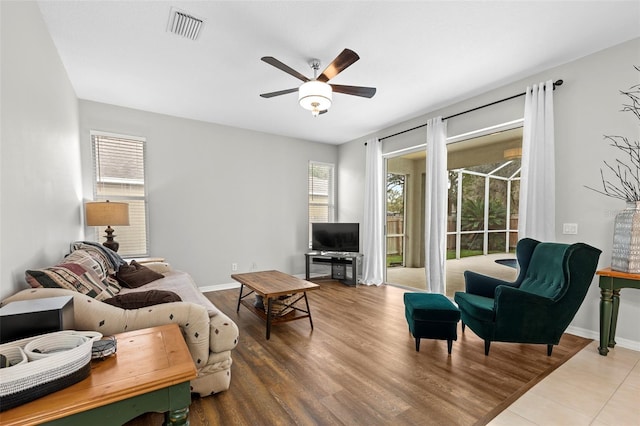 living room with ceiling fan and hardwood / wood-style floors