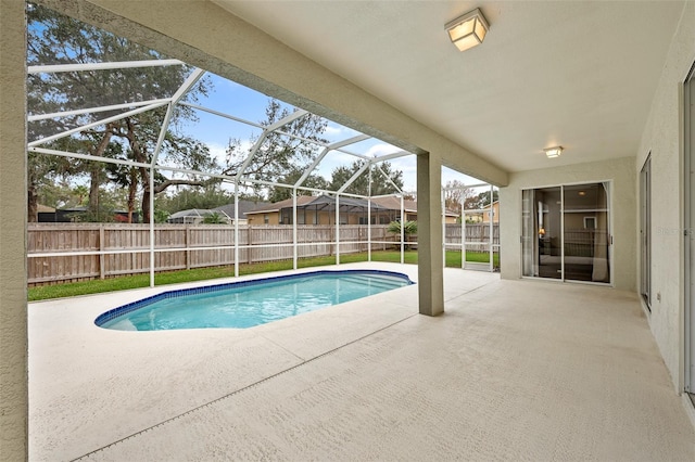 view of pool featuring glass enclosure and a patio area