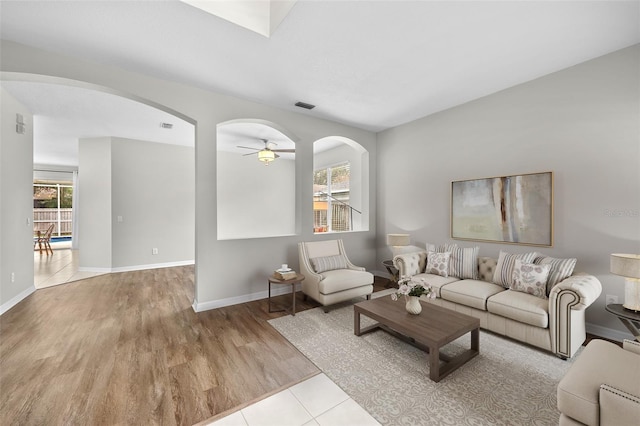 tiled living room featuring ceiling fan