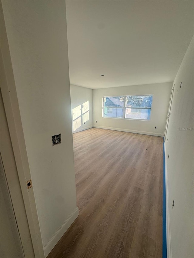 empty room with light hardwood / wood-style flooring