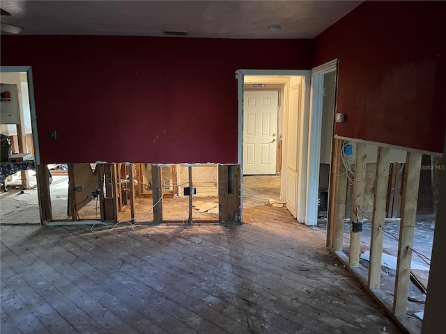 empty room with hardwood / wood-style flooring