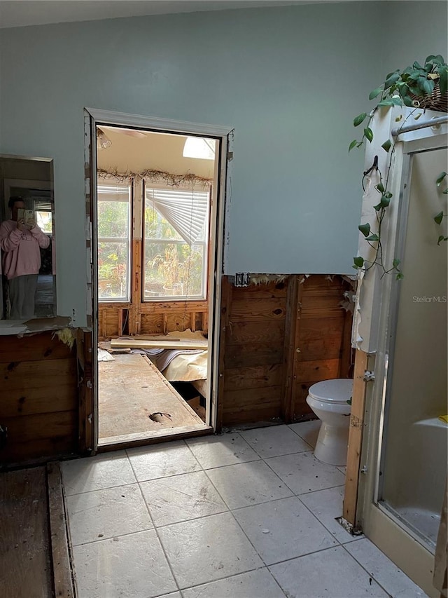 bathroom featuring toilet and lofted ceiling