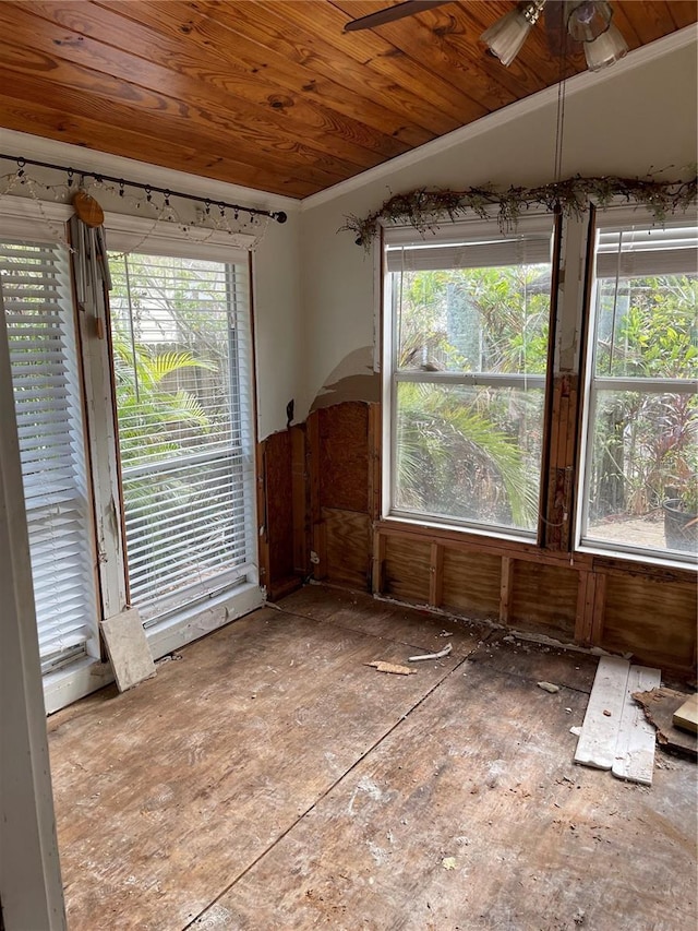 empty room with wooden ceiling, ceiling fan, and a healthy amount of sunlight