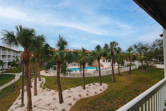 view of swimming pool featuring a lawn