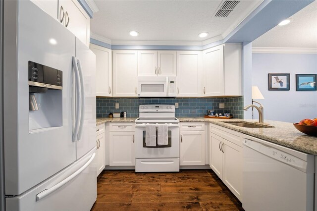 kitchen with white cabinets, sink, and white appliances