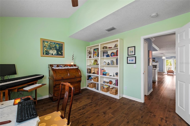 misc room with ceiling fan, dark hardwood / wood-style floors, and a textured ceiling