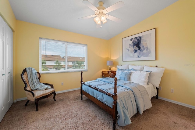 bedroom with light carpet, a closet, vaulted ceiling, and ceiling fan