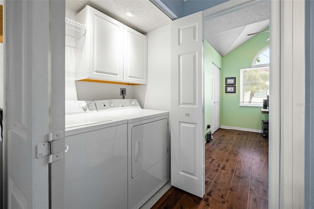 laundry area featuring cabinets, a textured ceiling, separate washer and dryer, and dark hardwood / wood-style flooring