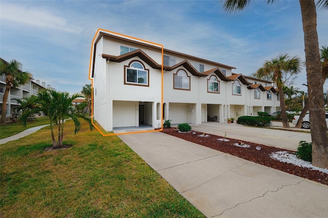 view of front of house with a front yard and a garage