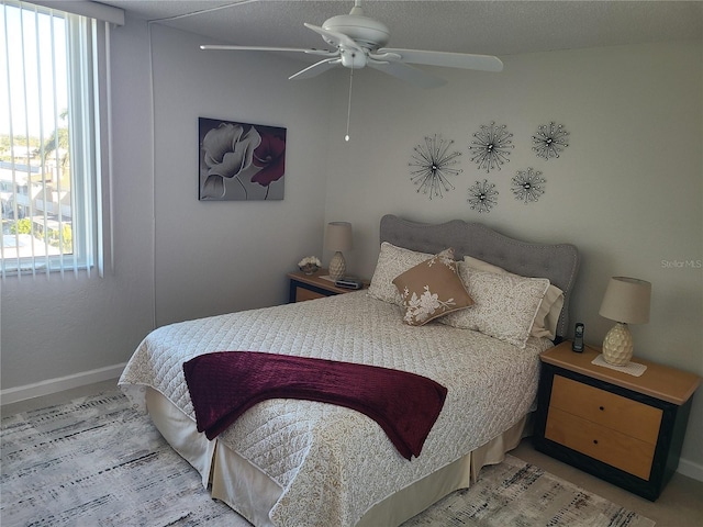 bedroom with ceiling fan and multiple windows