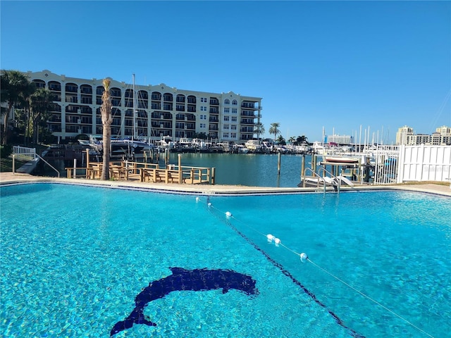 view of pool featuring a water view and a boat dock