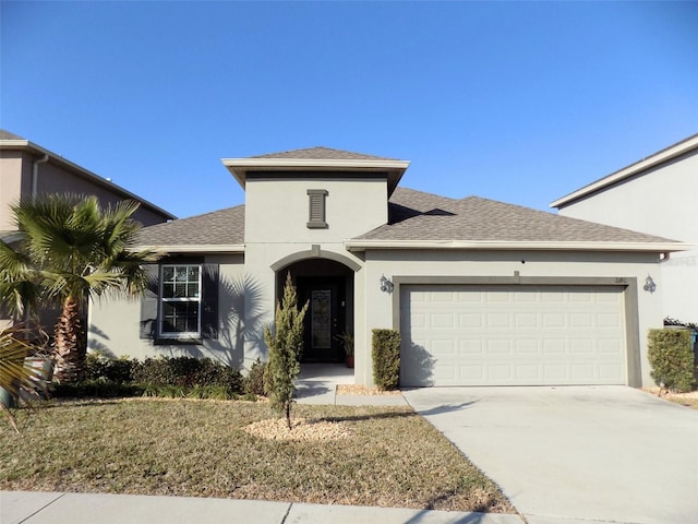 view of front facade with a front yard and a garage