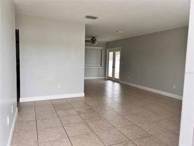 tiled spare room with french doors and ceiling fan