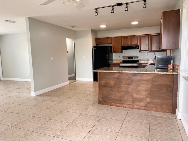 kitchen with light stone countertops, kitchen peninsula, black fridge, stainless steel electric stove, and light tile patterned floors