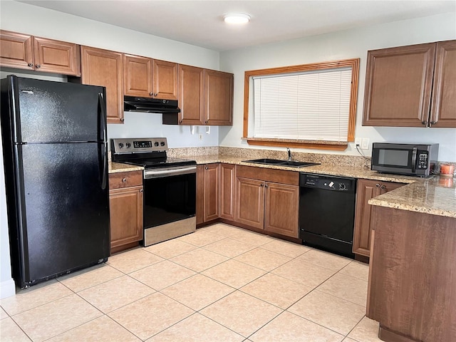 kitchen with sink, light tile patterned floors, black appliances, and light stone countertops