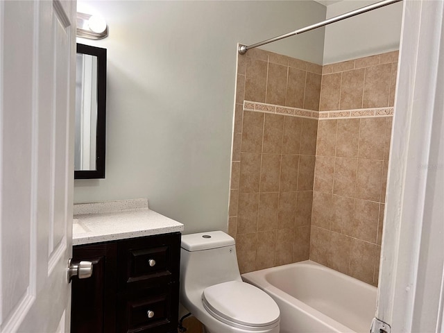 full bathroom with toilet, vanity, and tiled shower / bath combo