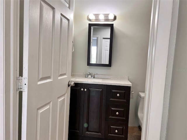 bathroom with toilet and vanity