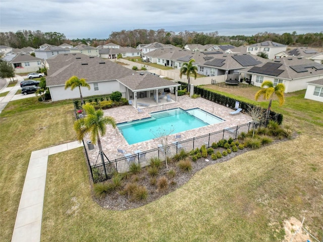 view of pool with a patio and a lawn