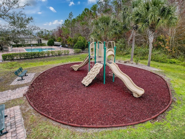 view of playground featuring a fenced in pool