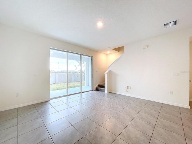 spare room featuring light tile patterned floors