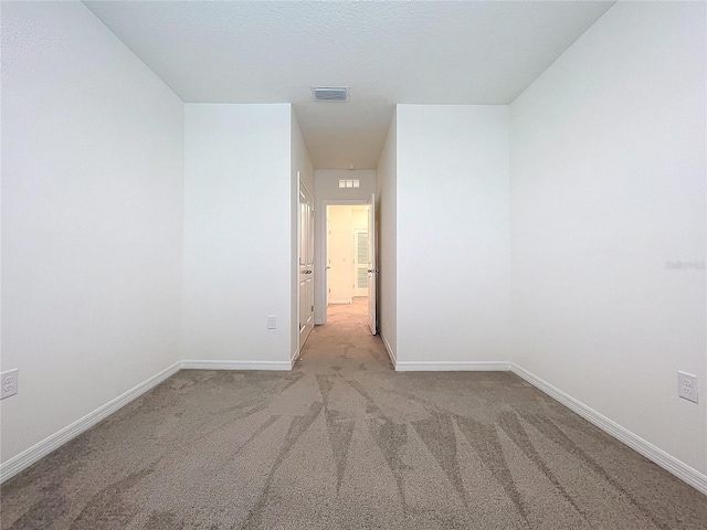 spare room with light colored carpet