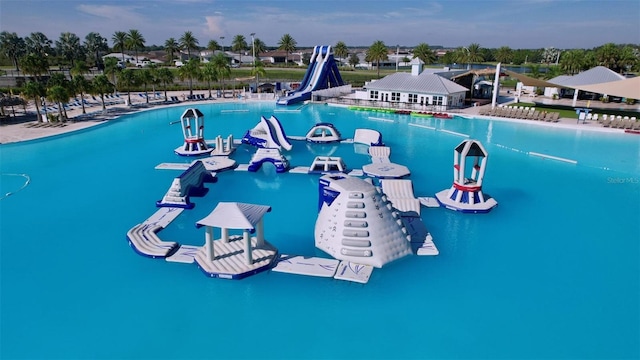 view of swimming pool with a water slide