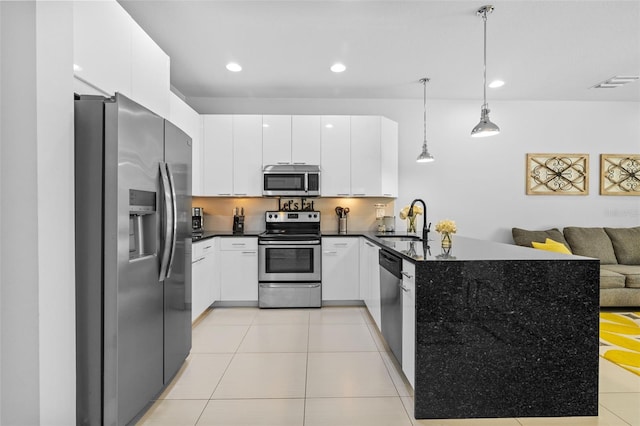 kitchen featuring pendant lighting, sink, light tile patterned floors, white cabinetry, and stainless steel appliances