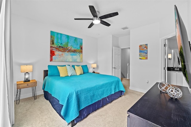 bedroom featuring light colored carpet and ceiling fan