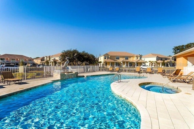 view of swimming pool with a patio area and a community hot tub