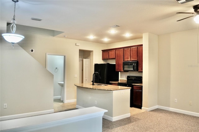 kitchen featuring ceiling fan, light colored carpet, black appliances, sink, and an island with sink