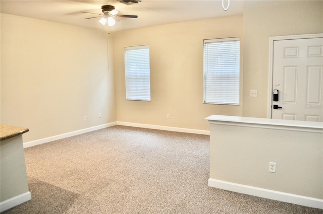 carpeted empty room with ceiling fan